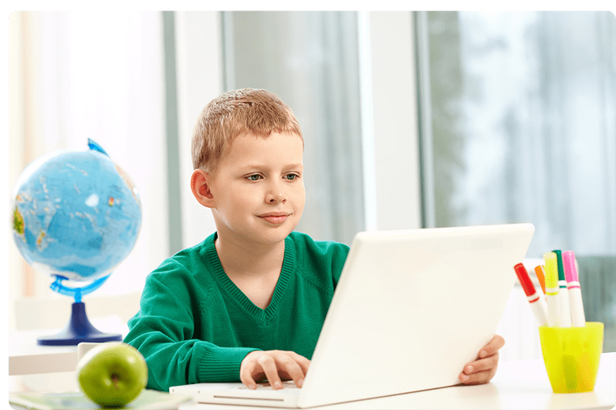 schoolboy-with-laptop-his-desk-min